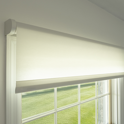 Draper at Home window shades featured in a well-appointed bedroom