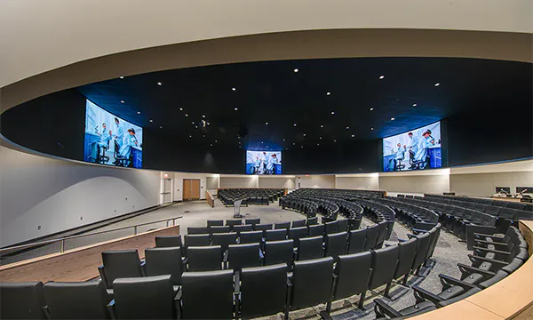 Tailored Draper mounting structures supporting curved Planar TVF video walls at a Mayo Clinic-Arizona State University facility.