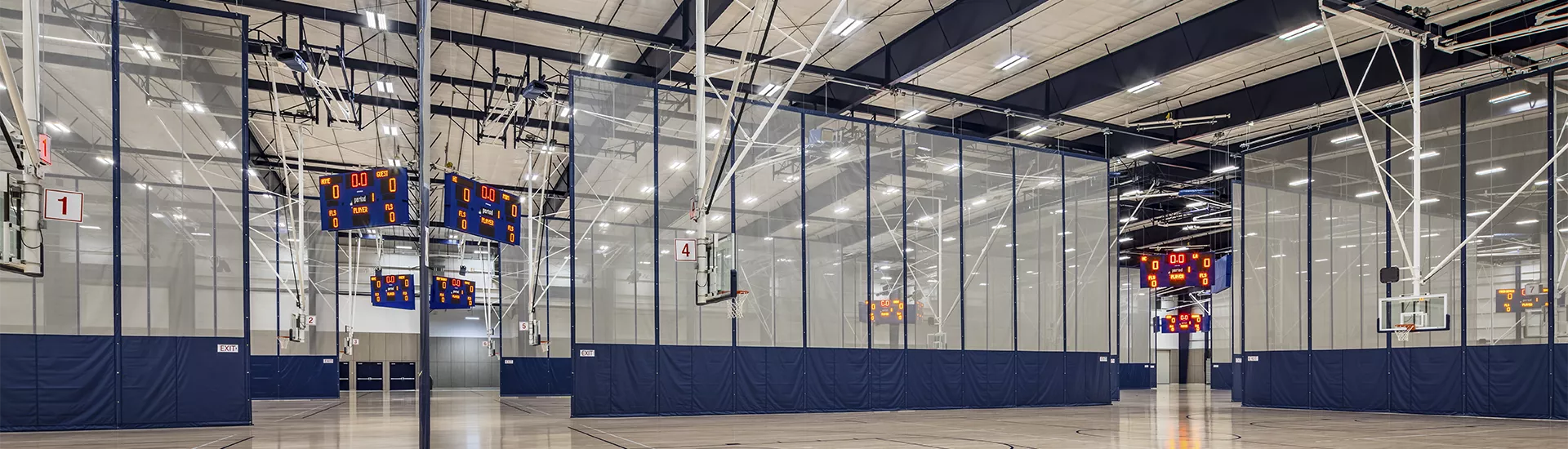 Gymnasium Dividers, Basketball Backstops with electric height adjusters, Overhead Volleyball Systems with judge's stands, scoreboard lifters, and Smart Gym Control System at the Roebbelen Center, Roseville, CA.